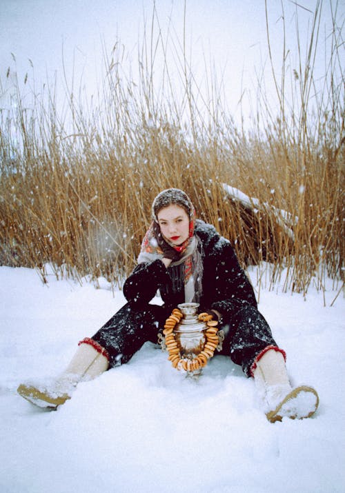 Woman with Headscarf Sitting on Snow