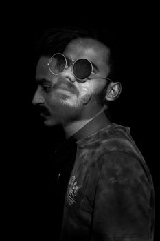 Artistic black and white double exposure portrait with sunglasses.