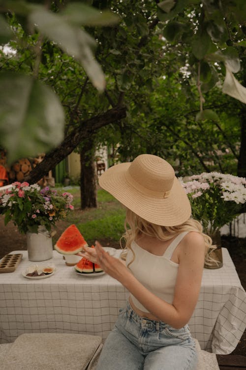 Woman Eating Watermelon in Garden 