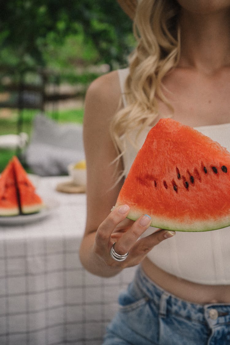 Woman Holding A Slice Of Watermelon