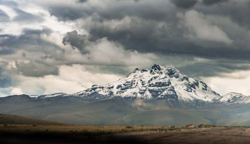 Snow Capped Mountain Under Cloudy Sky