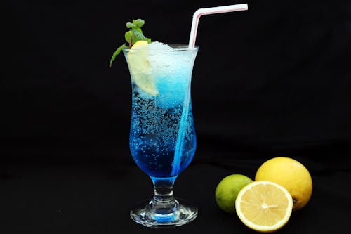 Blue and White Drink on Clear Cocktail Glass