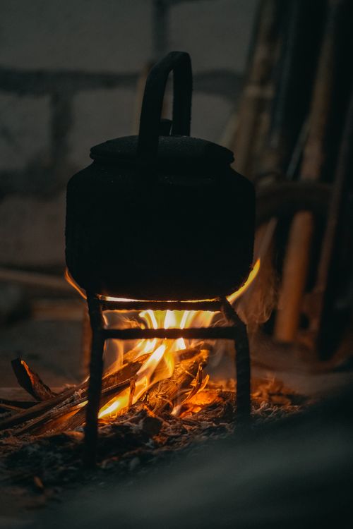 Free Cozy scene of an old kettle heated by an open fire, creating a warm ambiance. Stock Photo