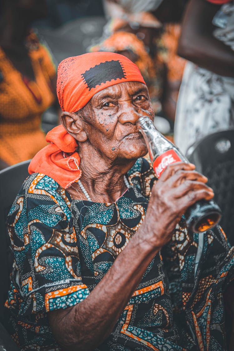 An Eldery Man Drinking Coca Cola 