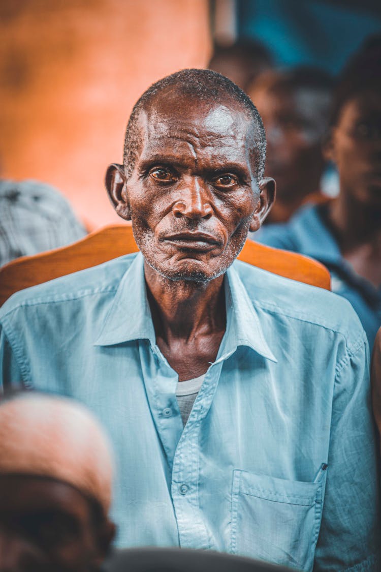 An Elderly Man In A Button Down Shirt 