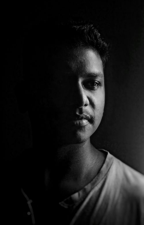 Free Moody monochrome portrait capturing the essence of a man in partial shadow. Stock Photo