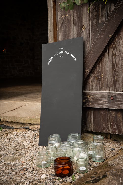 Clear Glass Jars Near Black Board