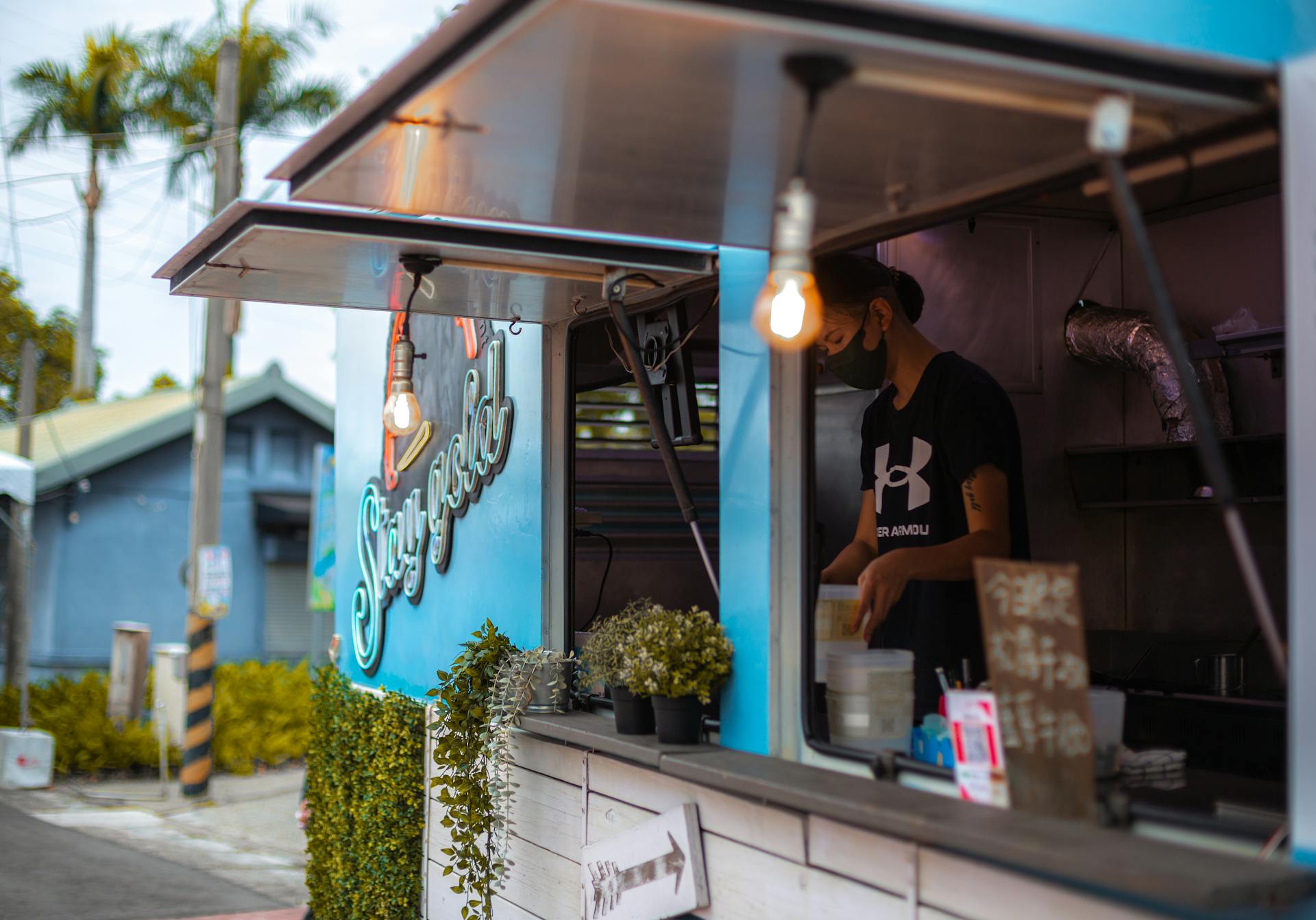 A modern food truck serving customers on an urban street, featuring vibrant decor.