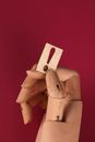 Wooden Hand holding a Wooden Exclamation Mark