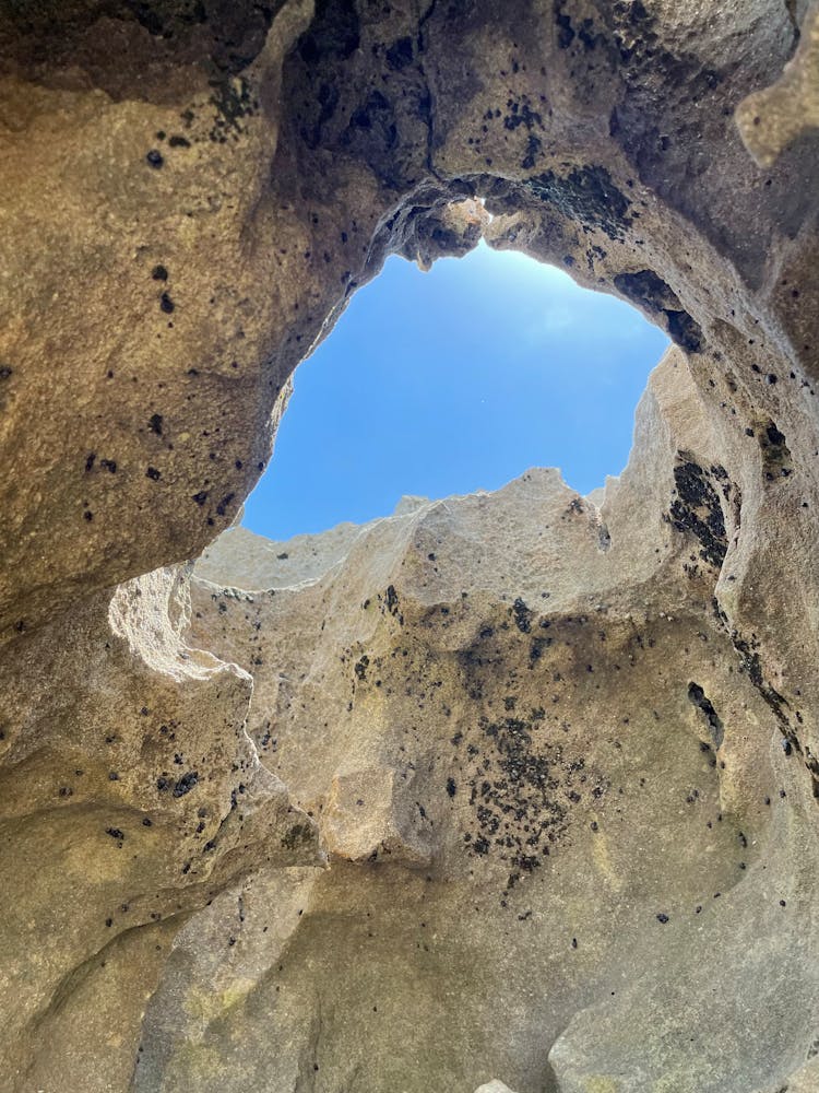 Clear Sky Behind Hole In Rocks