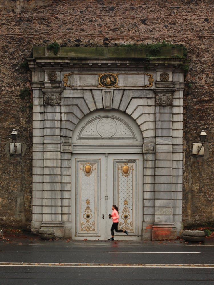 Woman Running Near Old Historic Building Doors