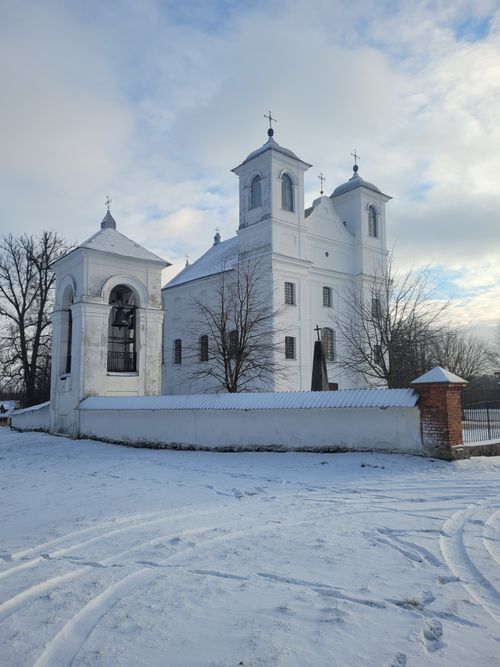 Free Beautiful snowy scene of a white church during winter with clear skies. Stock Photo