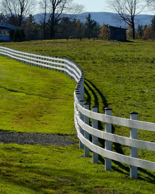 A Wooden Fence on Green Grass Field