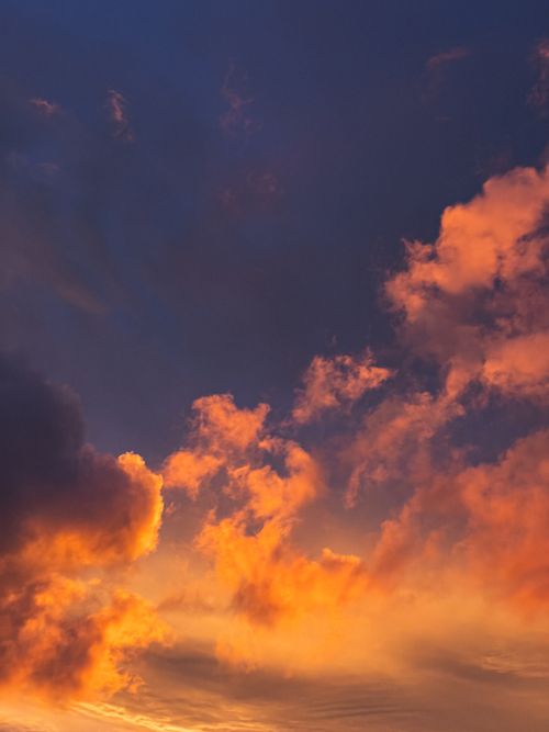 Free Vibrant orange and purple clouds during sunset over Montevideo, creating a dramatic sky. Stock Photo