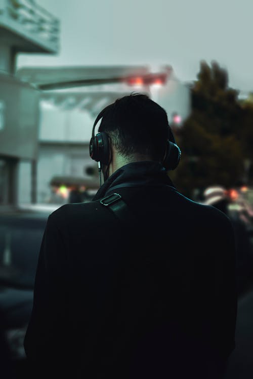 Free Backview of Man in Black Jacket Wearing Black Headphones Stock Photo