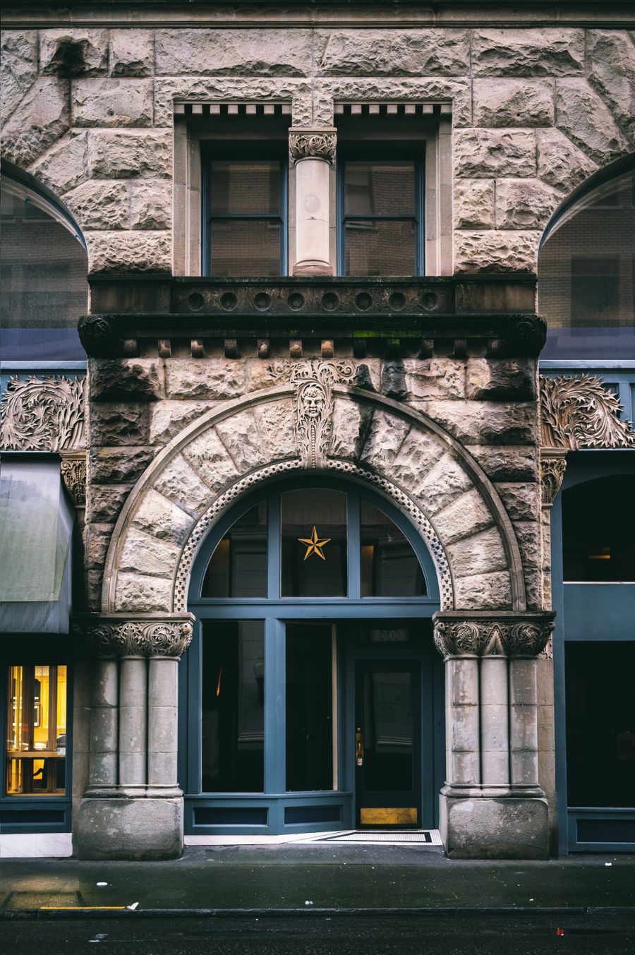 Arched stone entrance portal with carved surround