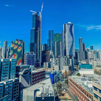 Captivating view of Melbourne's modern skyline under a bright blue sky, featuring iconic skyscrapers.