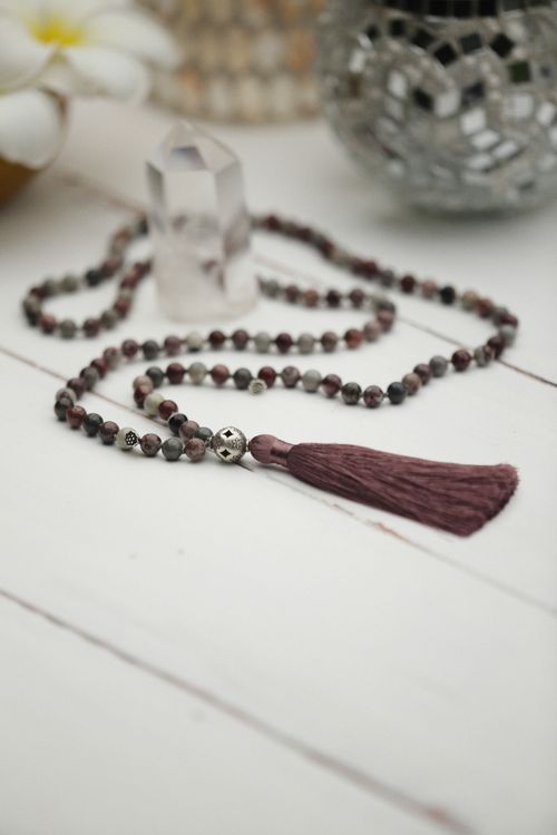 Free Handmade beaded necklace with tassel and crystal decor on a table. Stock Photo