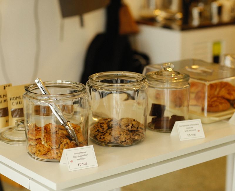 A variety of classic cookies and brownies arranged on a wooden table.