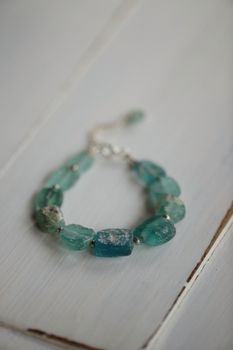 Close-up of an elegant blue stone bracelet with a rustic charm.