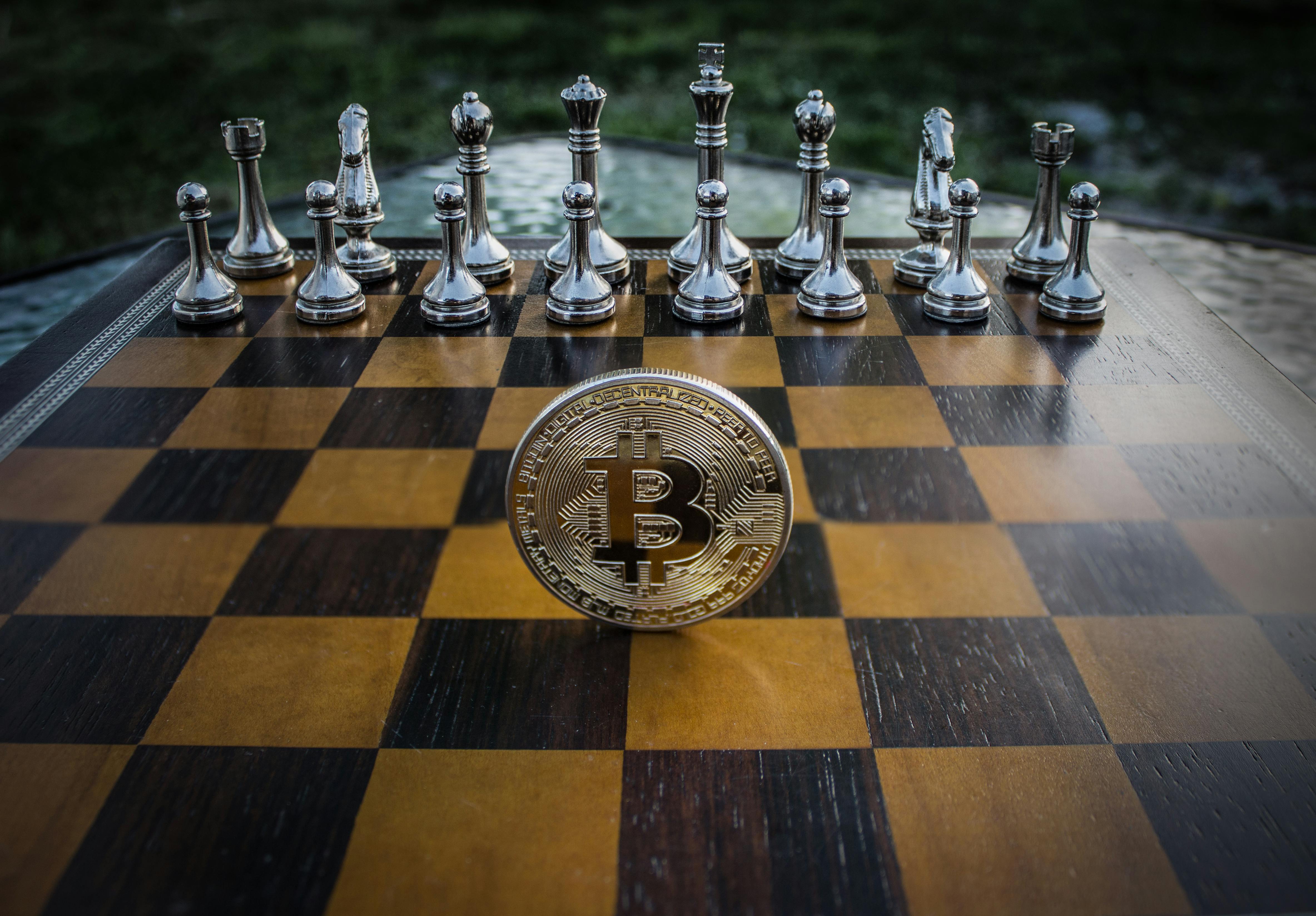 close up photography of coin on chessboard