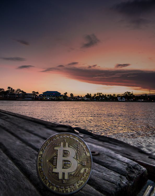 Free Body of Water during Dawn With Bitcoin Logo Text Overlay Stock Photo