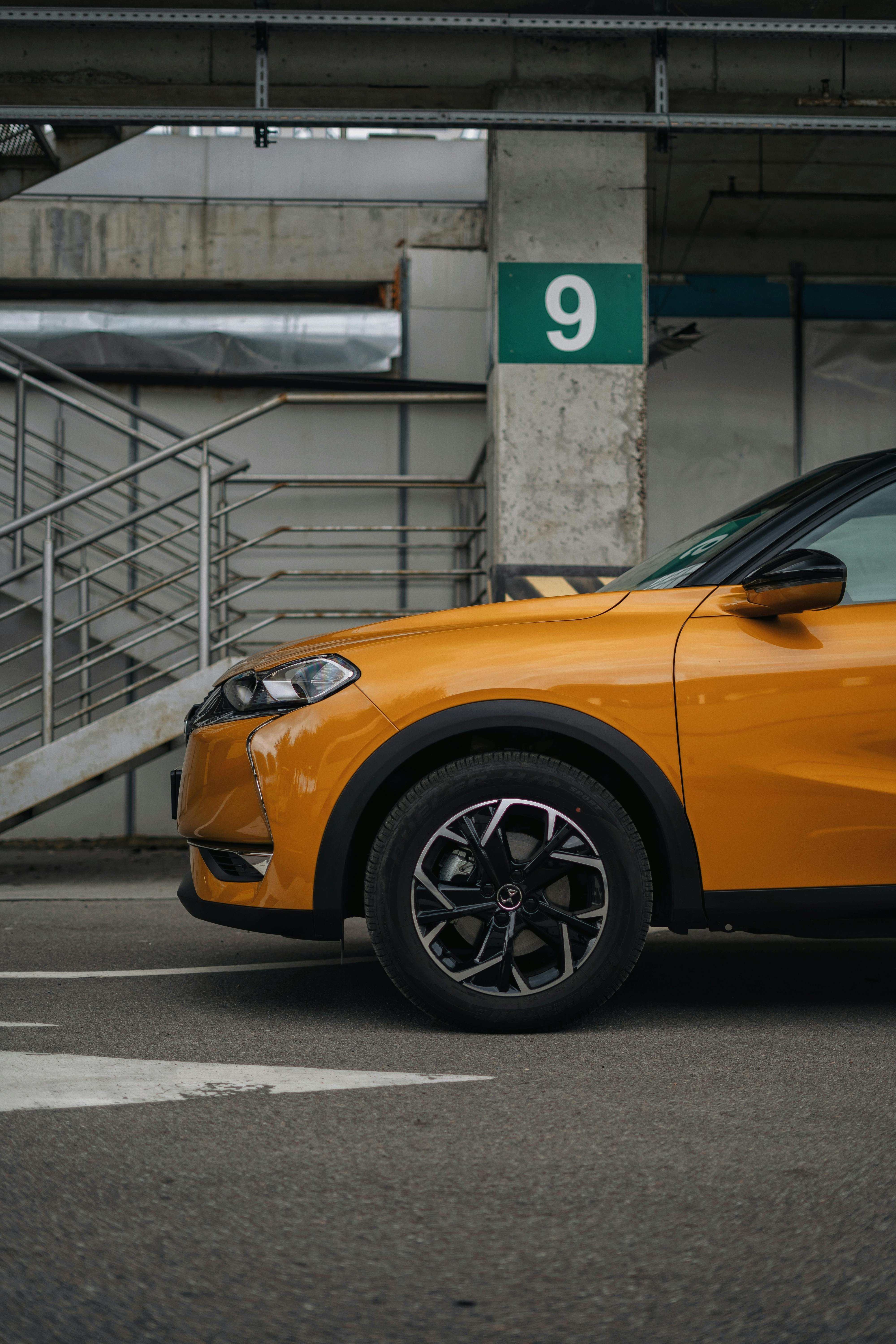 orange car in an underground car park