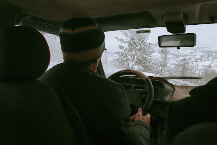 A Man Driving A Car