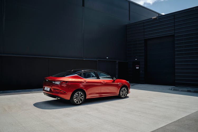 Red Luxury Car Parked In Front Of Garage