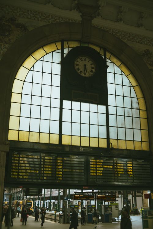 Free Interior view of the iconic São Bento Railway Station in Porto, featuring an arched window and clock. Stock Photo