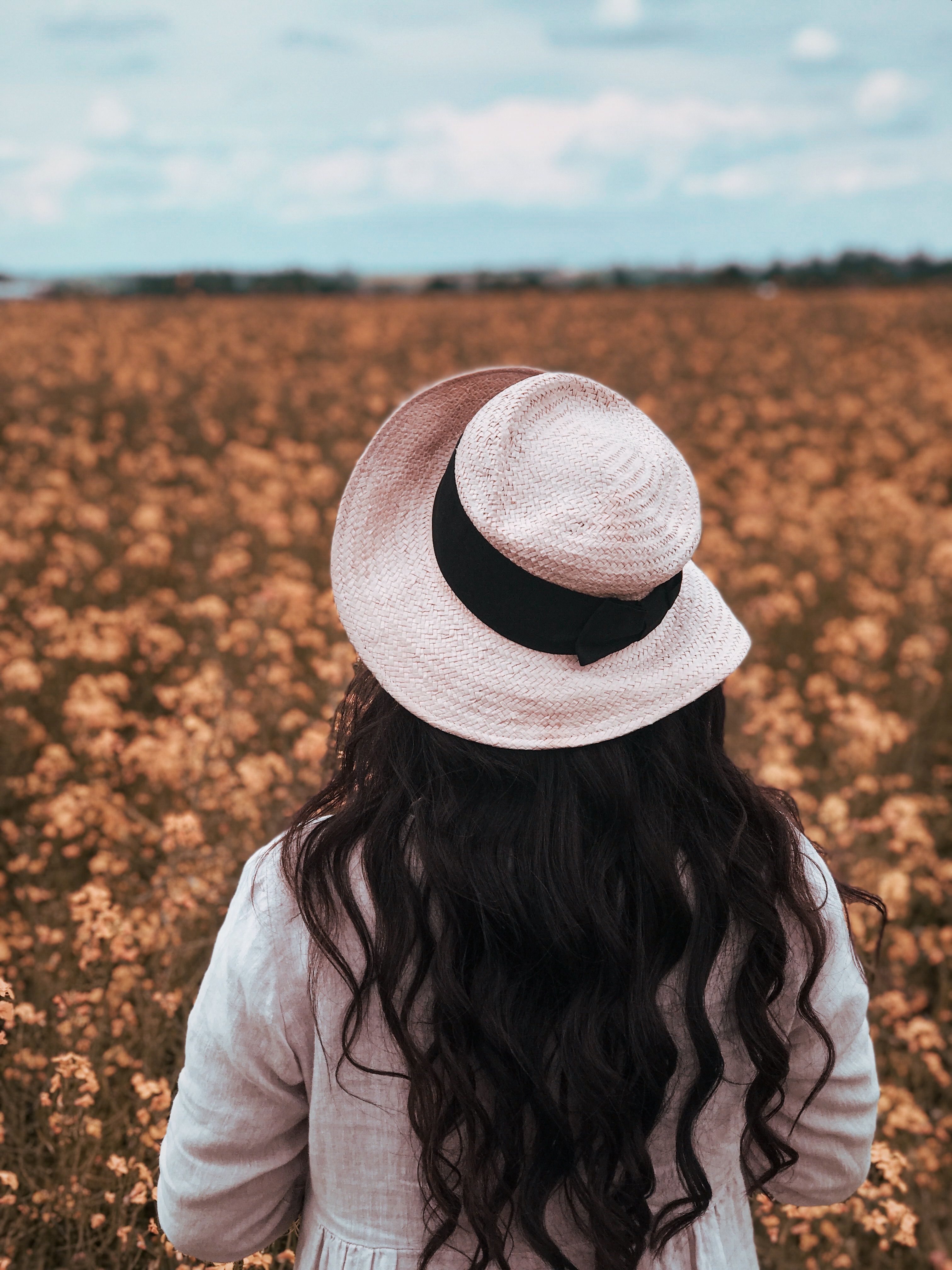 Woman in a Straw Hat and Green Dress by Bush Full of Red Roses · Free ...