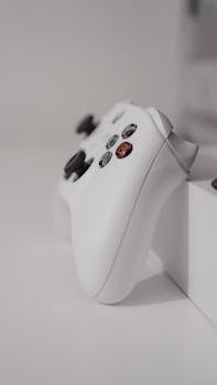Close-up of a white gaming controller on a sleek, minimalist surface, perfect for gaming enthusiasts.