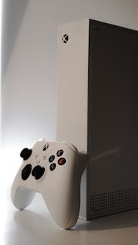 Close-up of a white Xbox console and controller, ideal for gaming enthusiasts and tech reviews.