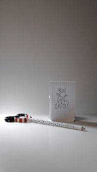 Inspirational message on paper with a pen and colorful scissors for creativity boost.