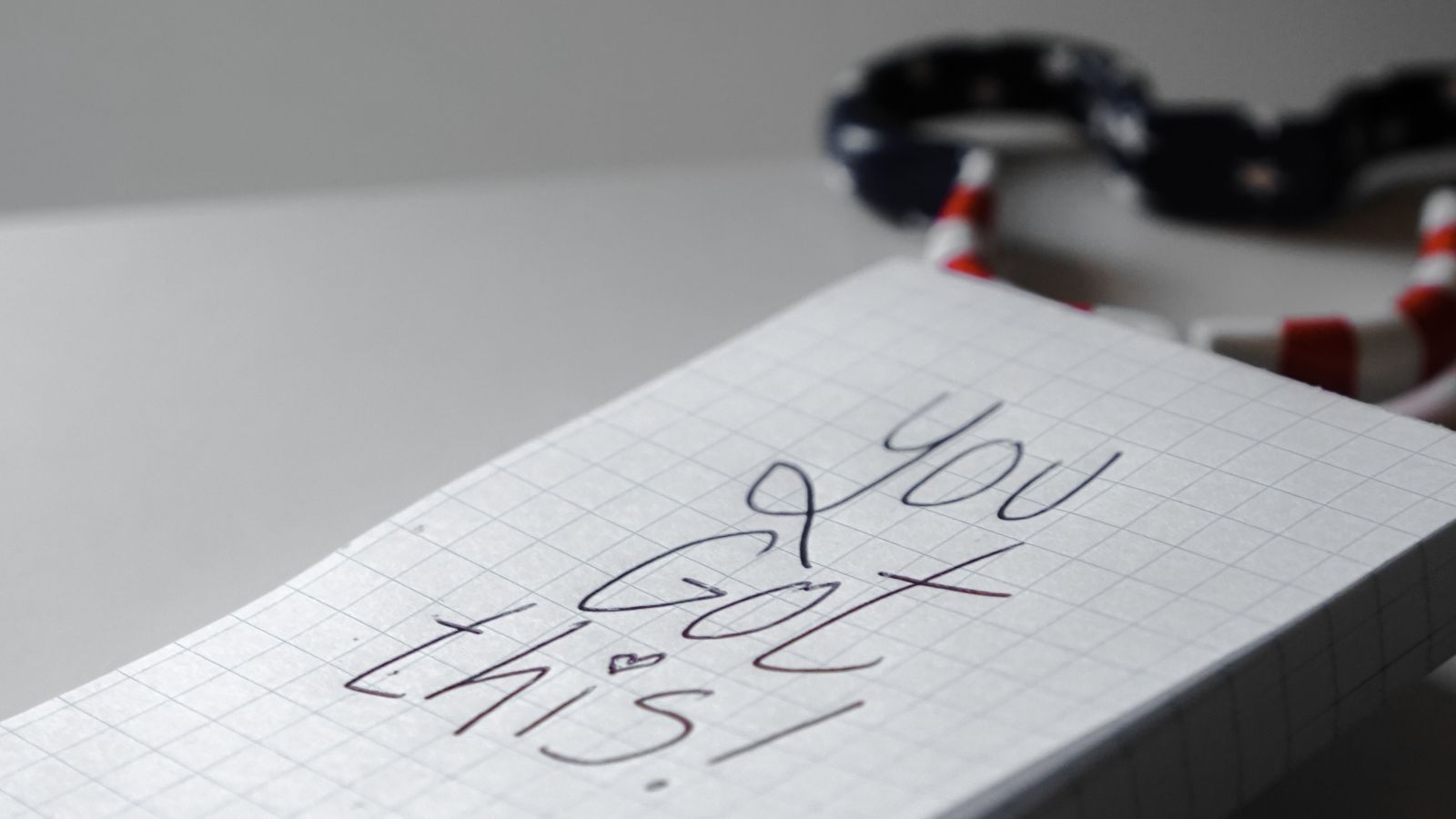 A handwritten “You Got This!” encouragement on a notepad beside a pen