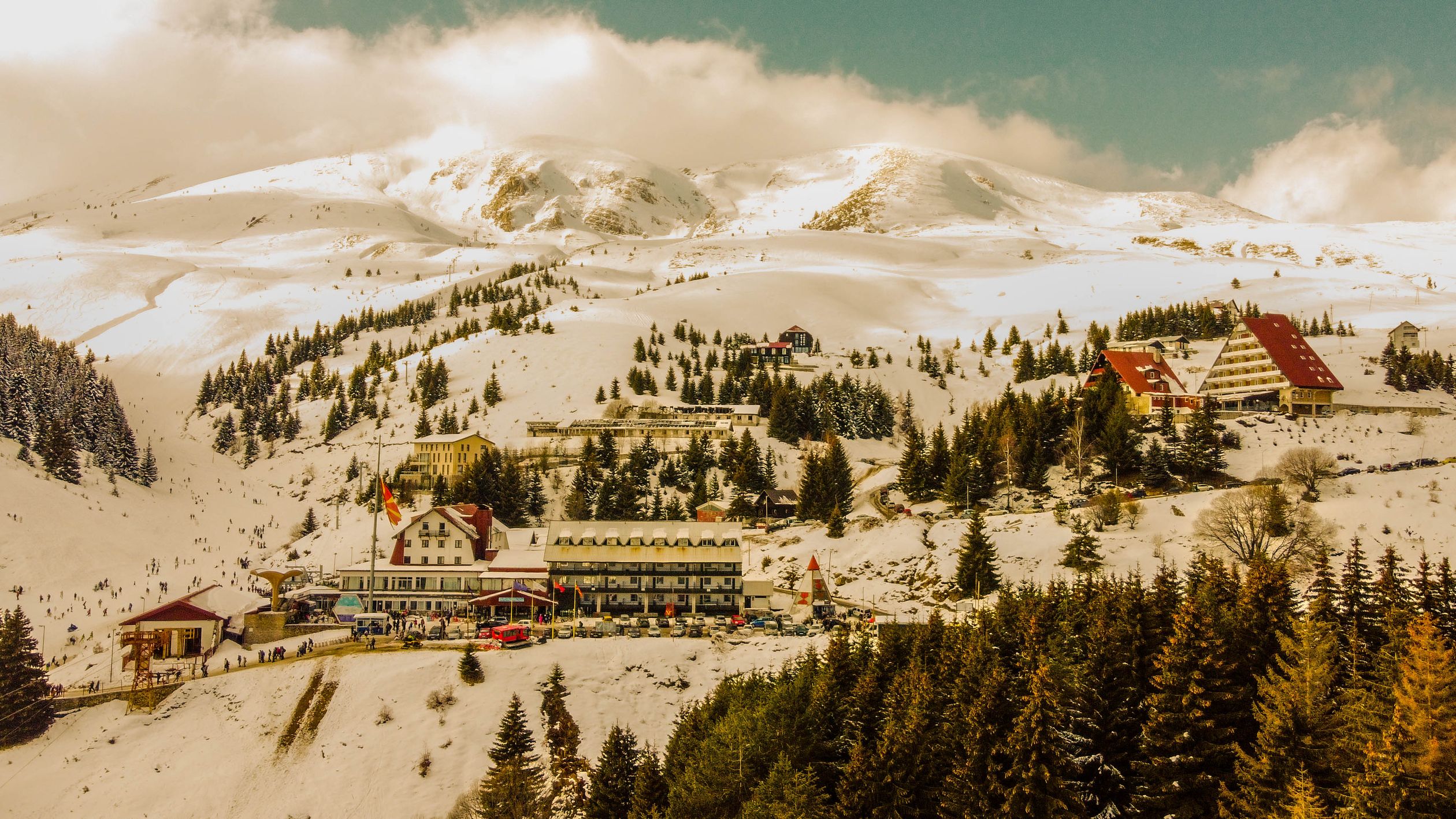 A picturesque ski resort showcasing snow-covered mountains and vibrant winter activities.