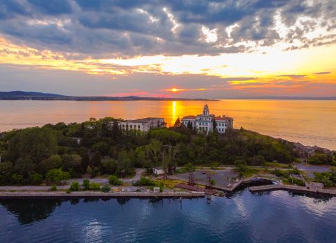 A stunning aerial view of Sozopol Island at sunset showcasing historic architecture and serene waters.