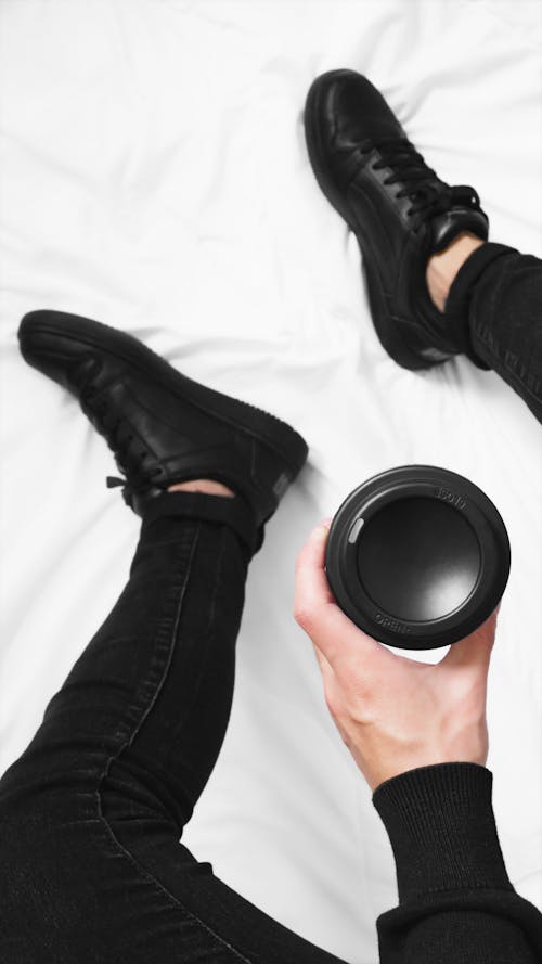 Man in Black Clothes and Shoes Holding a Disposable Coffee Cup 