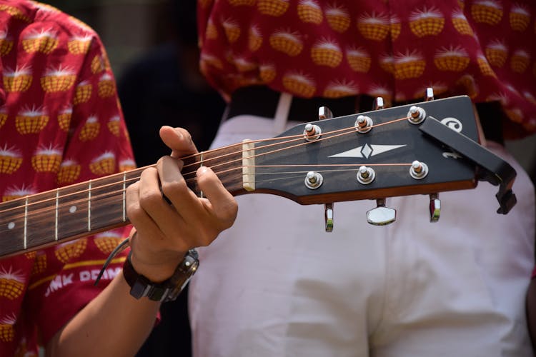 A Man Playing An Acoustic Guitar