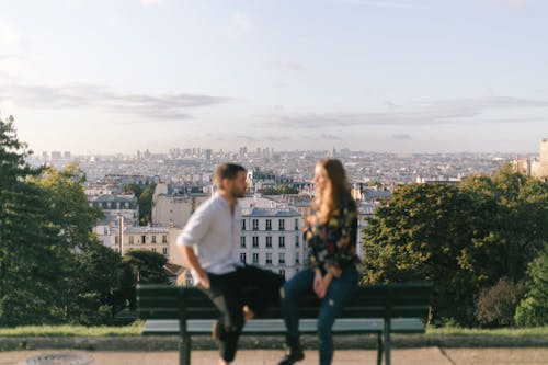 Free Cityscape behind Couple on Bench Stock Photo