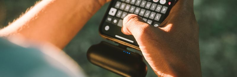 Portable power bank charging a smartphone