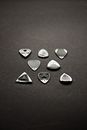 Silver Heart Shaped Accessory on Black Surface