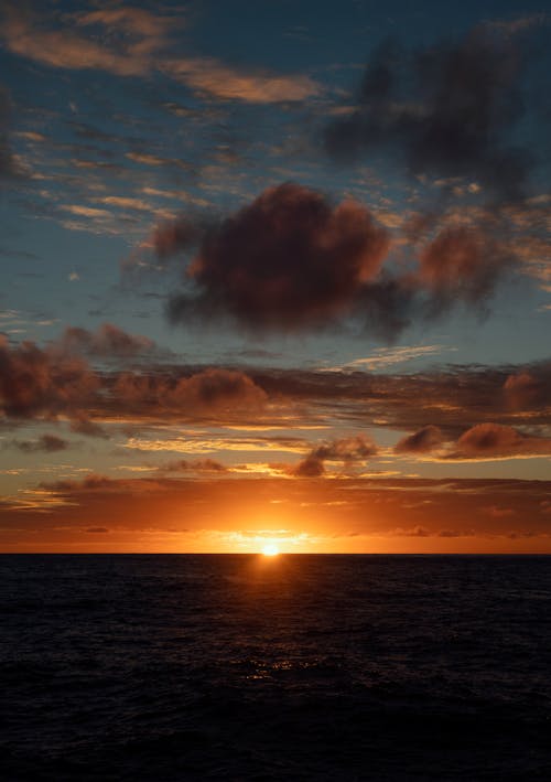 Dark Cloudscape with Yellow Sun and Seascape