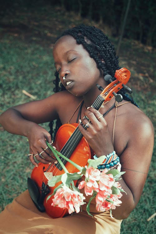 Woman Holding Violin and Flowers