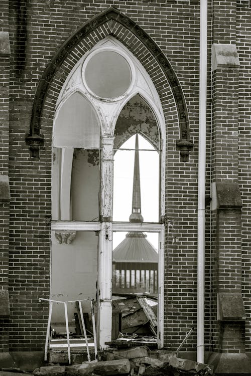 A Broken Glass Window on a Brick Building