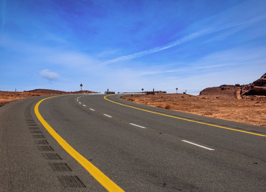 Scenic curved road cutting through the desert landscape in Tayma, Saudi Arabia.