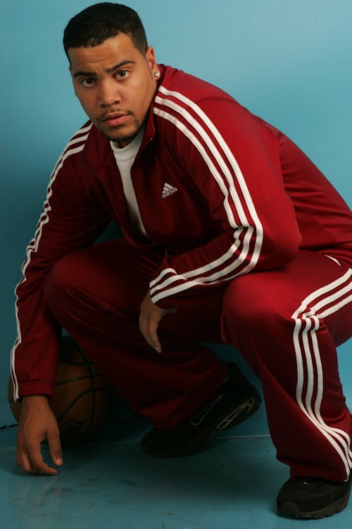 Man in Red Zip Up Jacket Holding Basketball