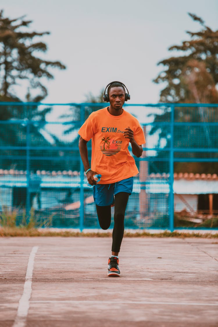 Man In Orange Shirt Running