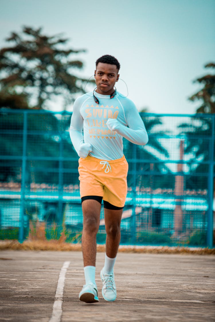 Young Man Running On The Track 