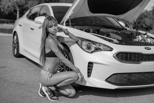 Free Woman in a Bikini Posing by a Kia Car Stock Photo